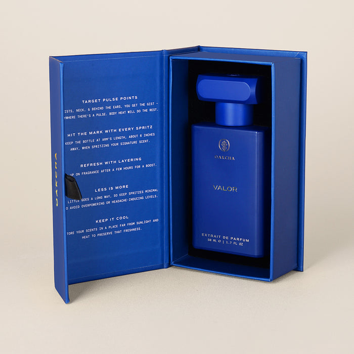 Three-quarter view of Valor bottle in open blue presentation box showing inner flap text on a neutral background