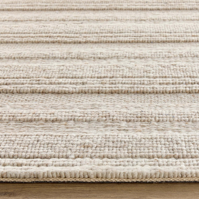 Close-up of the Chunky Knit Cream Wool Rug showing the pile height and the knitted pattern design.