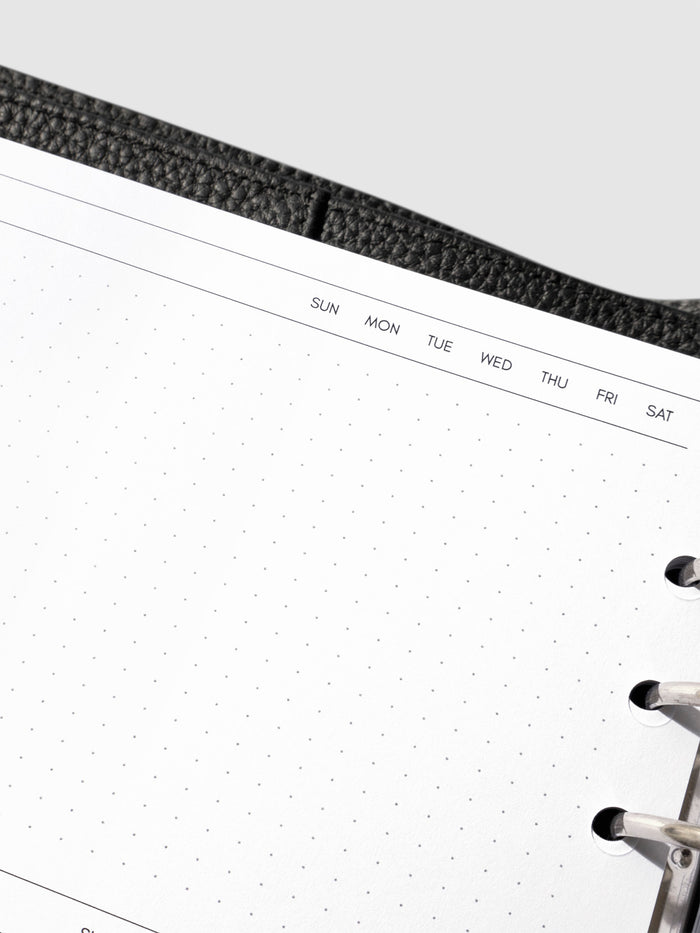 Closeup of inserts in use inside a leather planner.