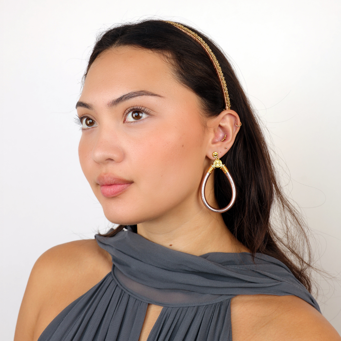a woman wearing a dress and earring