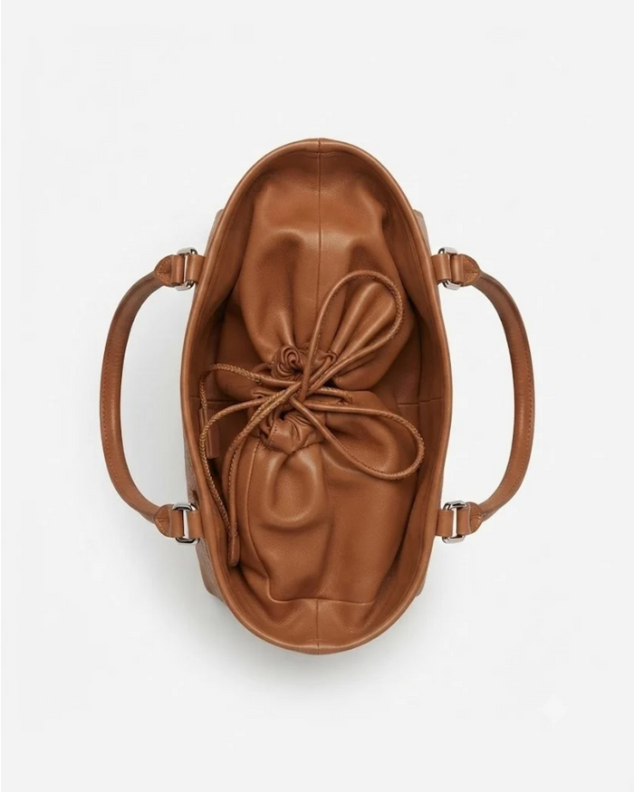 Tan leather-look oval drawstring handbag with bow-knot front and crossbody handles